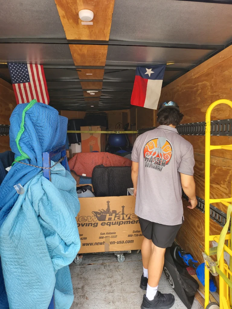 Interior of a moving truck showing flags and packed items.