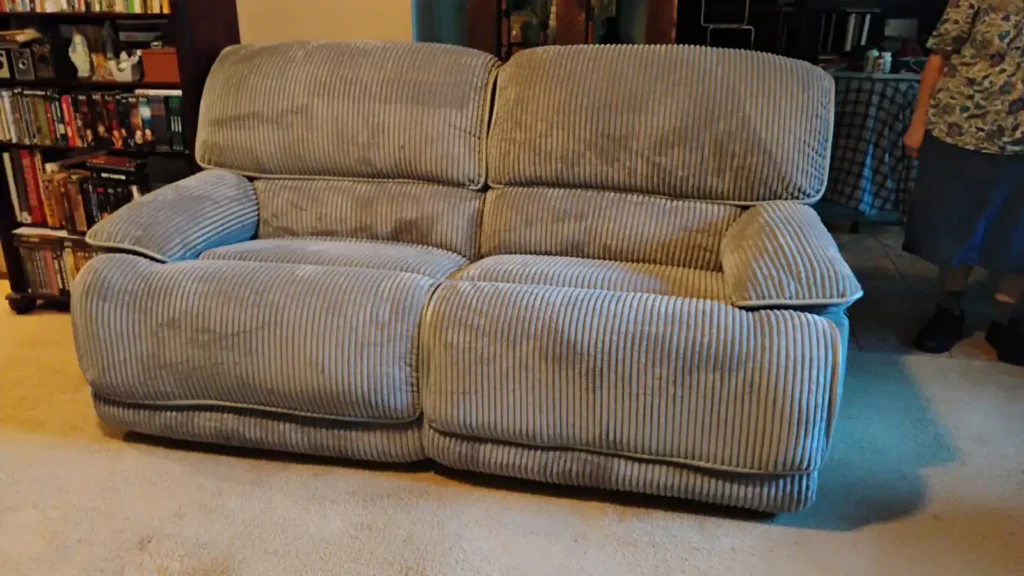 A cozy plush striped couch in a living room setting.