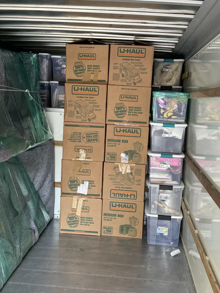 U-Haul boxes stacked in a moving truck for storage